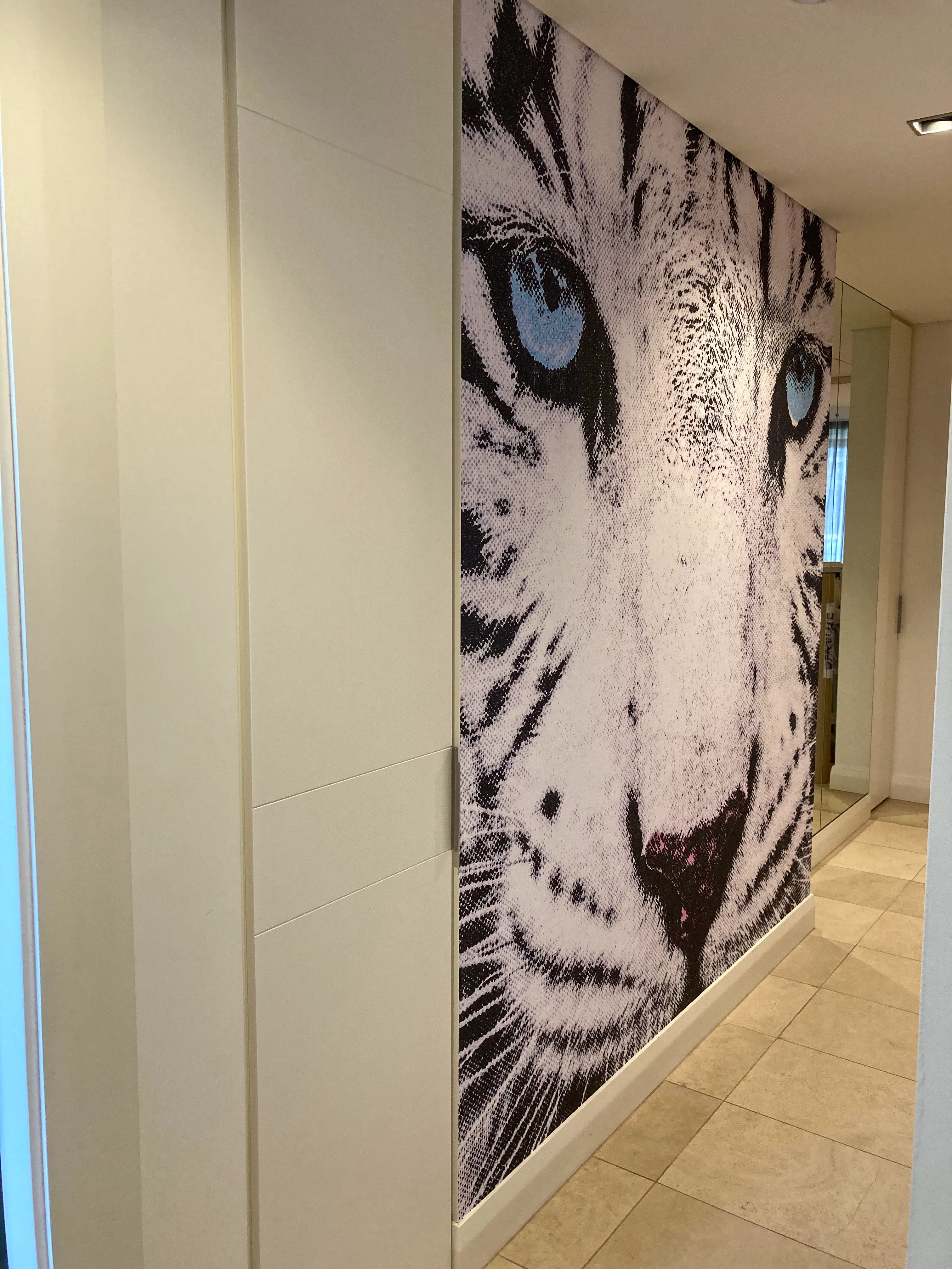 Stylised leopard photo on custom wallpaper in residential corridor