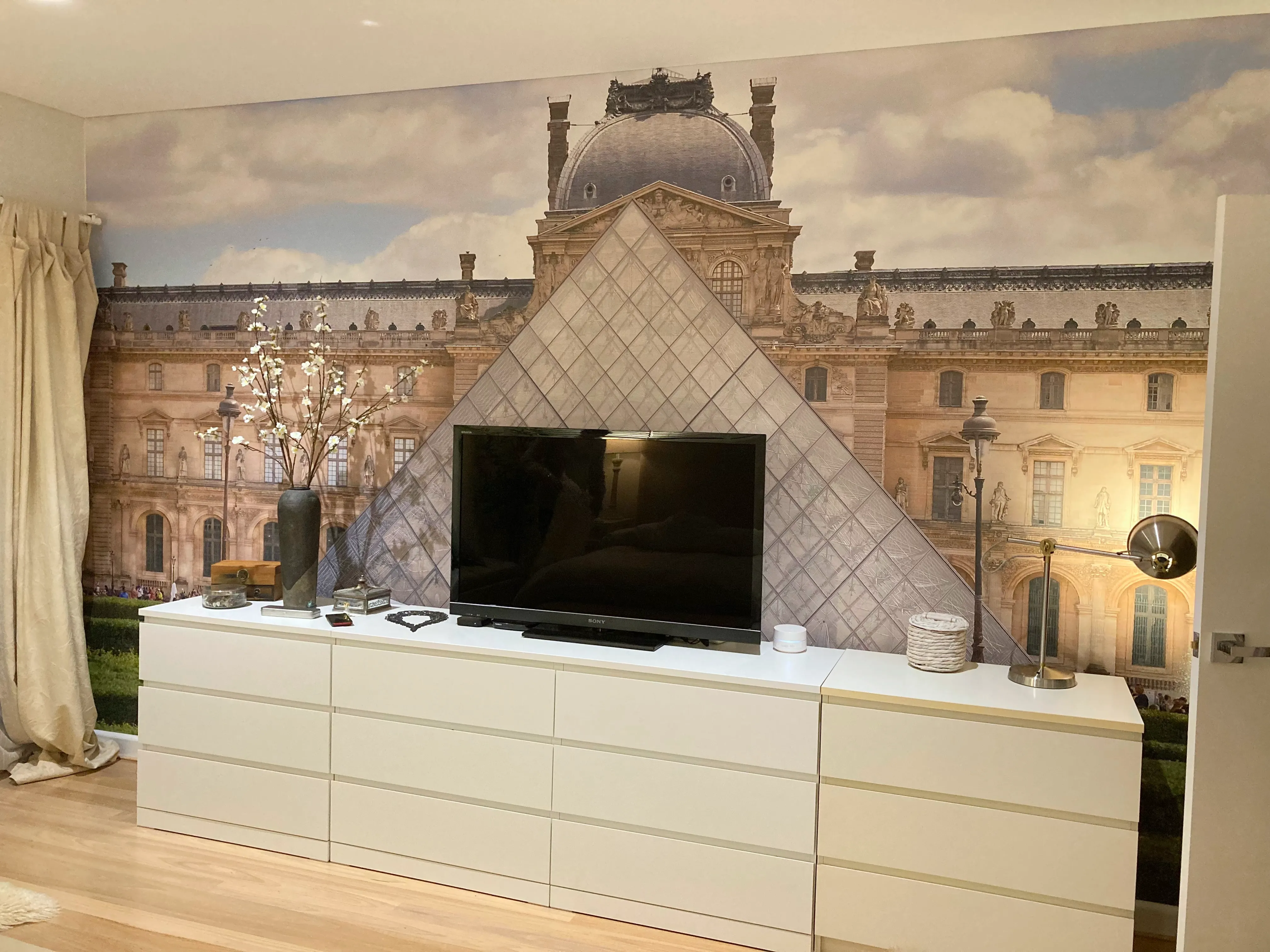 Bedroom with custom printed wallpaper mural of the Louvre building