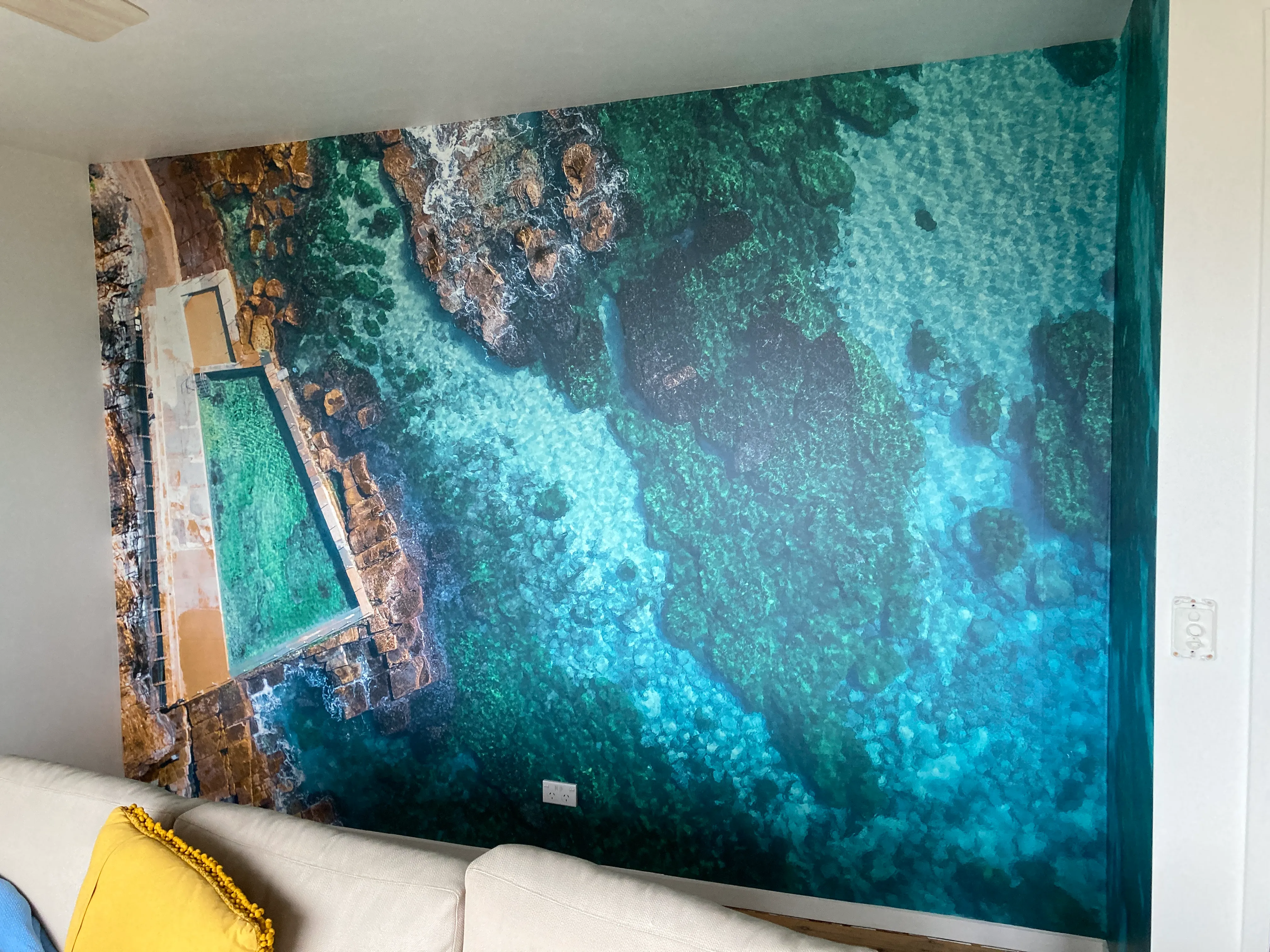 Living room wallpaper mural with aerial photo of roockpool in NSW